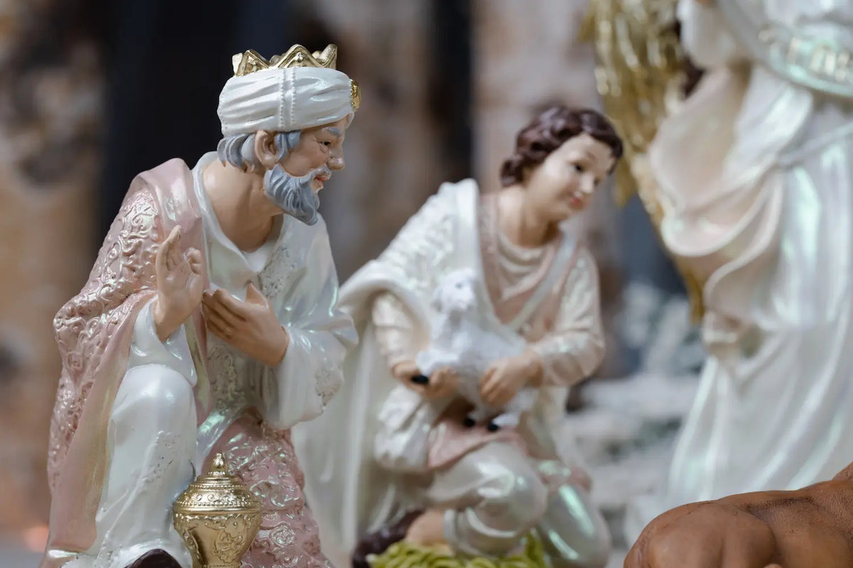 Pearlized Resin Nativity Figures in Blush Pink and Ivory with a Gloria Banner Angel and Straw Manger