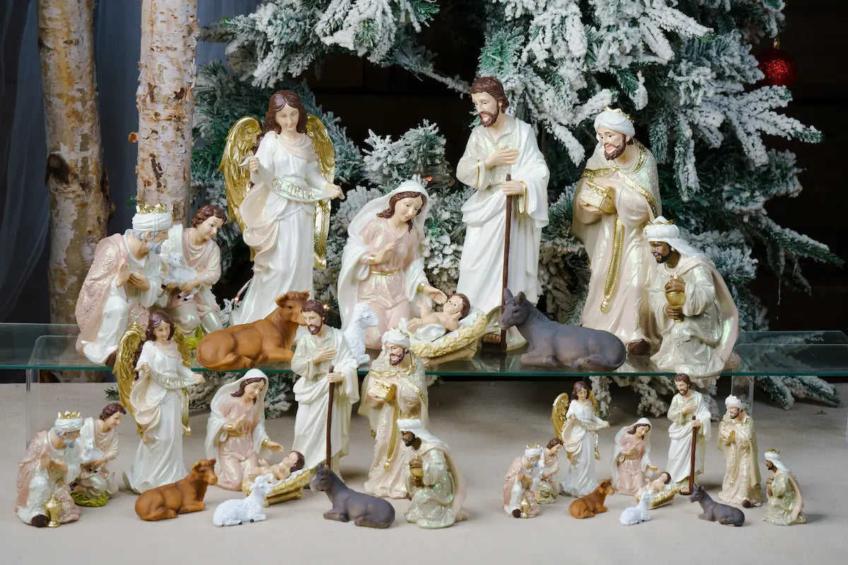 Pearlized Resin Nativity Figures in Blush Pink and Ivory with a Gloria Banner Angel and Straw Manger