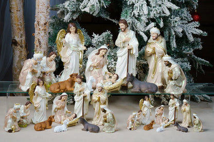 Pearlized Resin Nativity Figures in Blush Pink and Ivory with a Gloria Banner Angel and Straw Manger