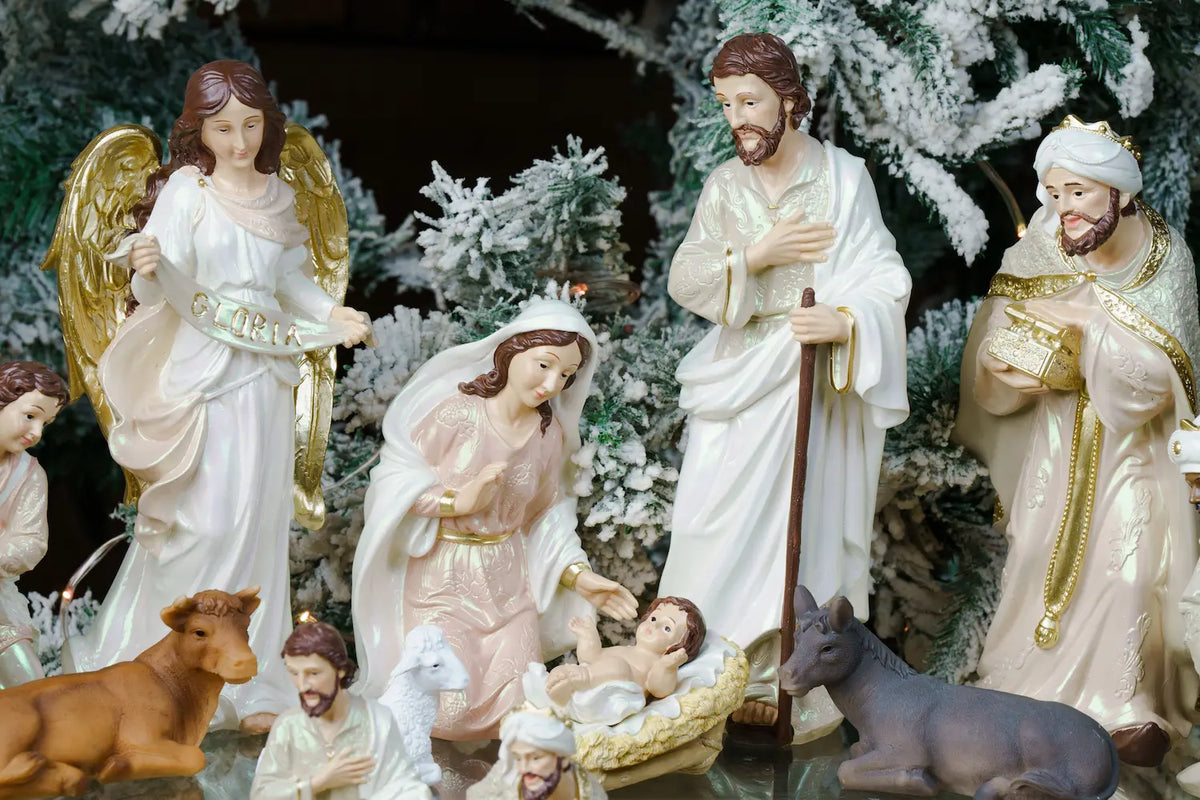 Pearlized Resin Nativity Figures in Blush Pink and Ivory with a Gloria Banner Angel and Straw Manger