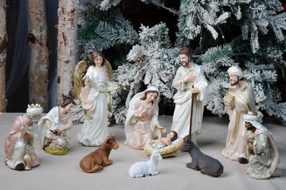 Pearlized Resin Nativity Figures in Blush Pink and Ivory with a Gloria Banner Angel and Straw Manger