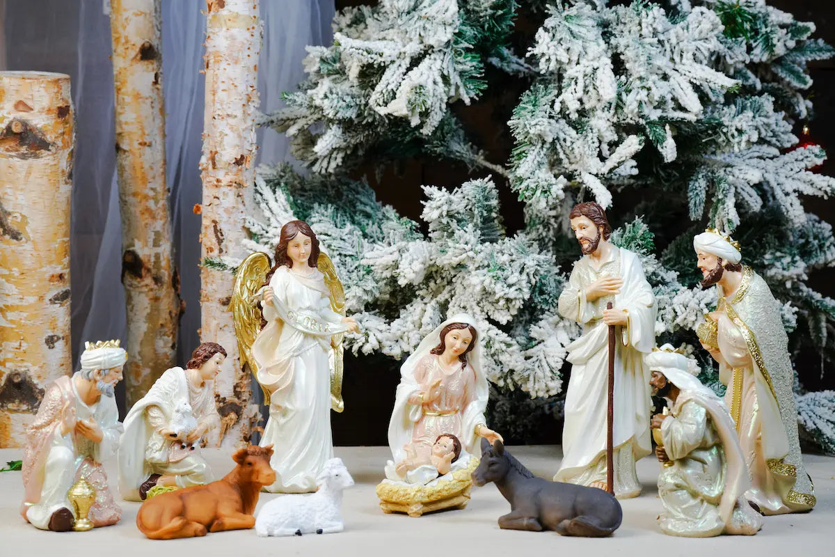 Pearlized Resin Nativity Figures in Blush Pink and Ivory with a Gloria Banner Angel and Straw Manger