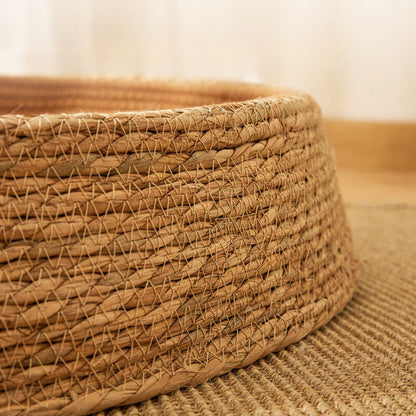 Stylish rattan cat bed and scratching post. Hand-woven, natural design for a comfortable pet home.