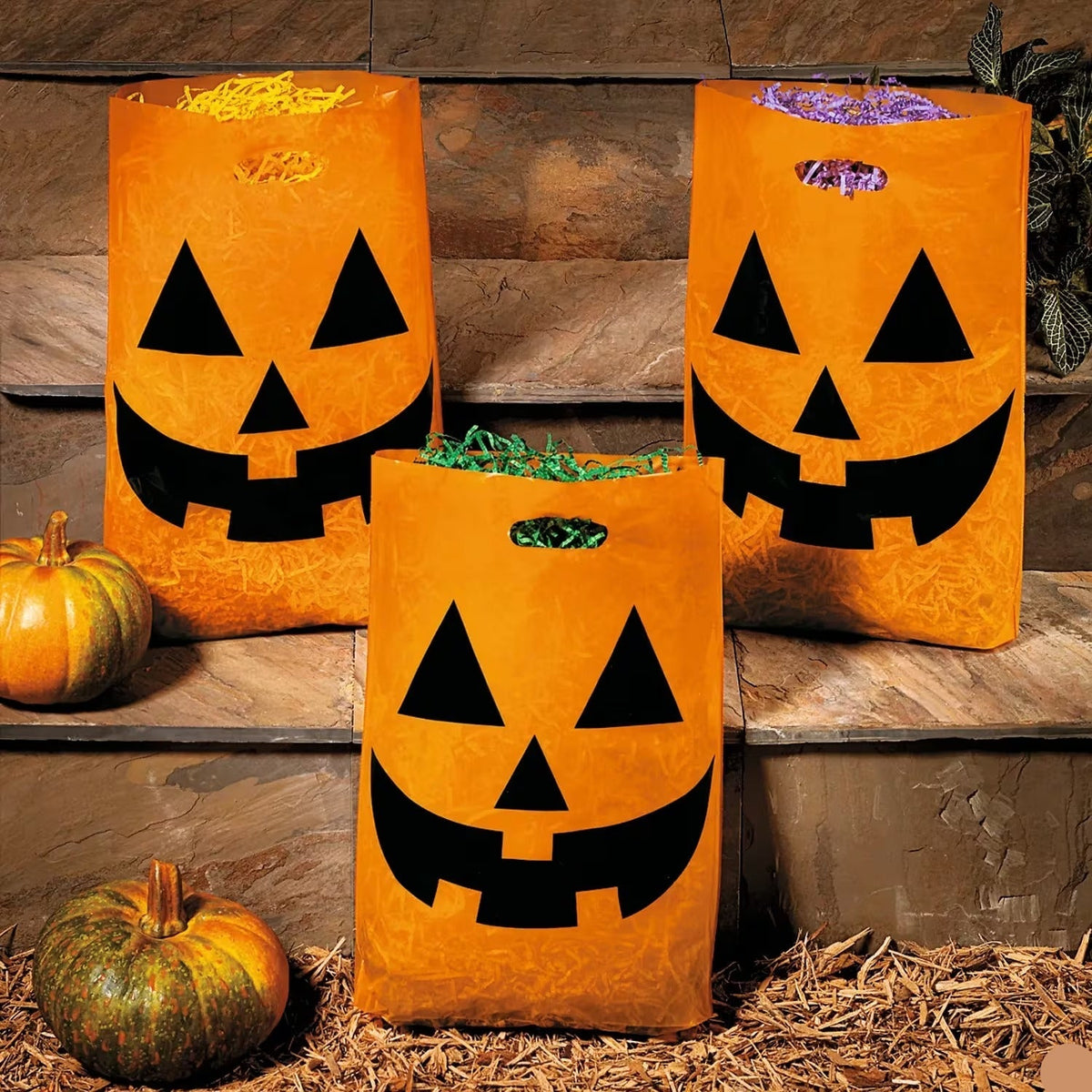 Large Plastic Halloween Bags Pack of 50 in Orange with Pumpkin Face and Handle Cutout for Candy Collecting
